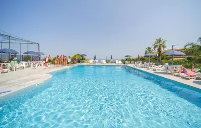 a large swimming pool with chairs and umbrellas at 2 Bedroom Amazing Home In Trabia in Trabia