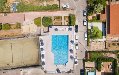 an overhead view of a parking lot with cars and a pool at 2 Bedroom Amazing Home In Trabia in Trabia