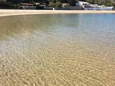 a body of water with a beach and houses at Casa Vacanze Karol in Trappeto