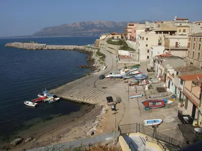 a group of boats on a beach next to the water at Casa Vacanze Karol in Trappeto