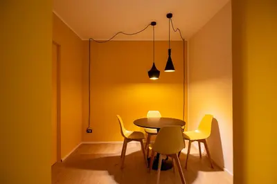 a living room with yellow walls and a couch at LEGO36 Apartment in Palermo