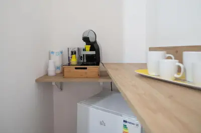 a kitchen with a counter with a coffee maker on a shelf at Casa Doriana in Palermo