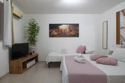 two beds in a room with a tv at Casa Doriana in Palermo