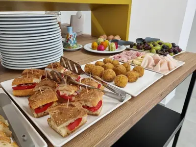 a table with sandwiches and appetizers and plates of food at Hotel Arte Mare - camere in via del mulino 45 in San Vito lo Capo