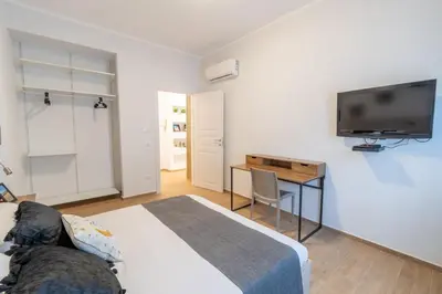 a bedroom with a bed and a television on a wall at LE TRE CHIAVI Apartment in Palermo