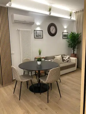 a living room with a table and chairs and a couch at LE TRE CHIAVI Apartment in Palermo