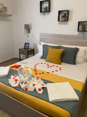a bed with two swans and towels on it at LE TRE CHIAVI Apartment in Palermo