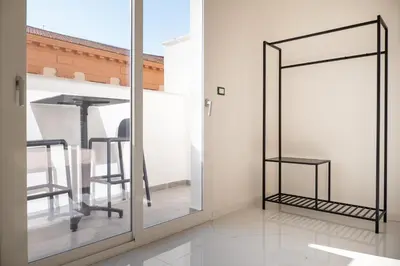 a mirror in a room with a table and chairs at Casa M al Teatro Massimo in Palermo