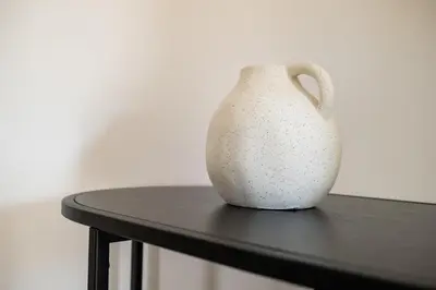 a white vase sitting on top of a table at Casa M al Teatro Massimo in Palermo