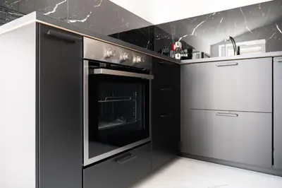 a black and white kitchen with an oven at Casa M al Teatro Massimo in Palermo