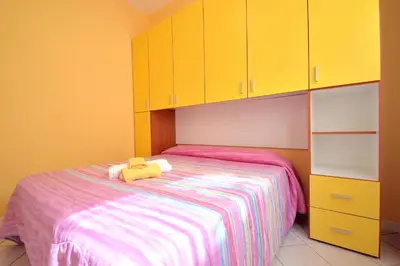 a bedroom with a bed with a stuffed animal on it at case vacanze piccolo in Balestrate