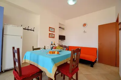 a dining room with a table with a bowl of fruit on it at case vacanze piccolo in Balestrate
