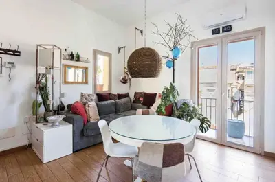 a living room with a couch and a table at Appartamento nel centro storico di Palermo in Palermo