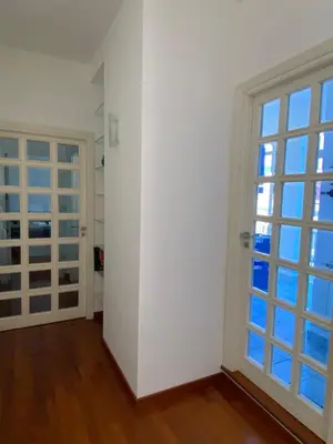 a room with white walls and a large window at MaDà holiday house ideale per coppie o famiglie in Palermo