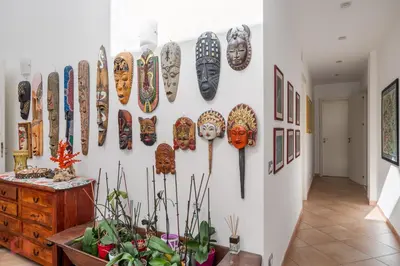 a wall with a bunch of masks on it at Villa vista mare e piscina privata ad Alcamo in Alcamo