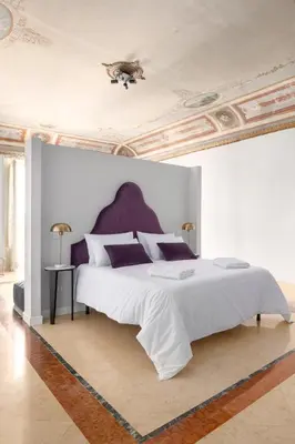 a bedroom with a large white bed with a ceiling at Verosicily Sant'Elia suite in Palermo