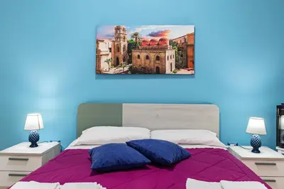 a bedroom with a bed with two pillows on it at Sicily Trinacria House in Palermo