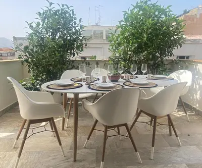 a table and chairs sitting on a roof at Dimora D'aumale in Palermo