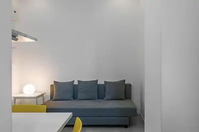 a living room with a blue couch and chairs at GuestHost - Ballarò Market Cozy Apartments in Palermo