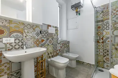 a bathroom with a sink and a toilet at GuestHost - Ballarò Market Cozy Apartments in Palermo