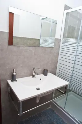a bathroom with a sink and a mirror at Papillon BnB in Palermo