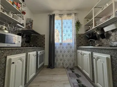 a kitchen with a sink and a window at Relais Rosa Apartment in Palermo