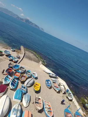 a group of boats on a beach near the ocean at La Rondine Bed in Ficarazzi