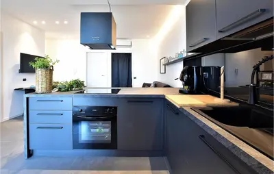 a kitchen with a blue oven in the middle at 2 Bedroom Awesome Apartment In Trappeto in Trappeto