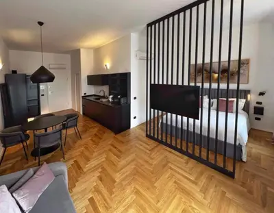 a living room with a bed and a dining room at Giglio luxury apartment in casa professa in Palermo