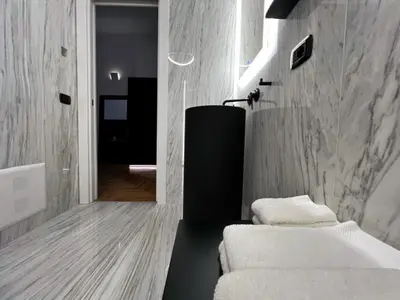 a living room with a bed and a hallway at Giglio luxury apartment in casa professa in Palermo