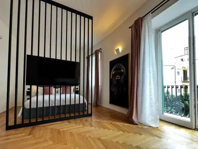 a bedroom with a bed and a large window at Giglio luxury apartment in casa professa in Palermo