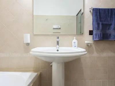 a bathroom with a sink and a mirror and a tub at Holiday Home Perla by Interhome in Partinico