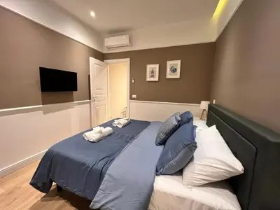a bedroom with a bed with two pillows on it at Florio House in Palermo