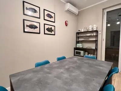 a meeting room with a table and blue chairs at Florio House in Palermo