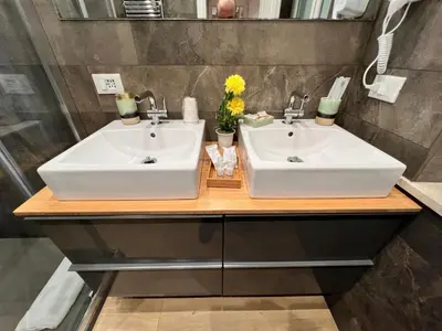 two sinks on a wooden counter in a bathroom at Florio House in Palermo