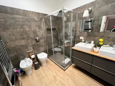 a bathroom with a shower and a toilet and a sink at Florio House in Palermo