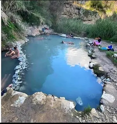 a group of people in a pool of blue water at Casa gli Oleandri in Castellammare del Golfo