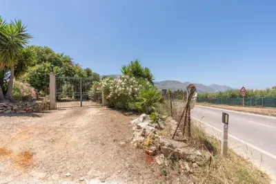 a fence on the side of a road at Casa gli Oleandri in Castellammare del Golfo