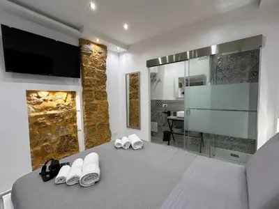 a bedroom with two pairs of slippers on a bed at Ó sole mio in Palermo