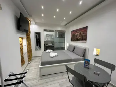 a bedroom with a bed and a table and a television at Ó sole mio in Palermo