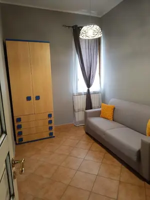 a living room with a couch and a window at Casa del mare Mely in Ficarazzi