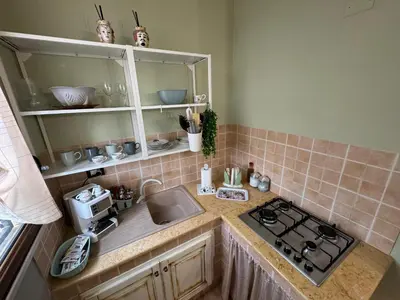 a kitchen with a sink and a counter with a stove at Casa del mare Mely in Ficarazzi
