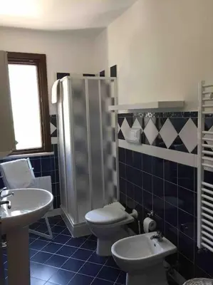a bathroom with a shower and a toilet and a sink at Villa sole Sicily in Terrasini