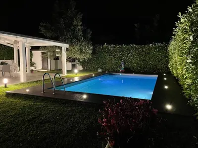 a swimming pool in a yard at night at Villa sole Sicily in Terrasini