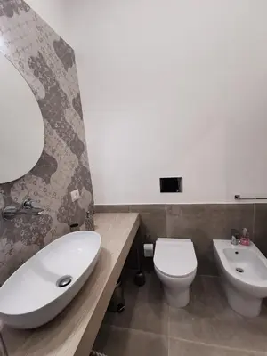 a bathroom with a white sink and a toilet at Casarino House Luxury Apartment in Palermo