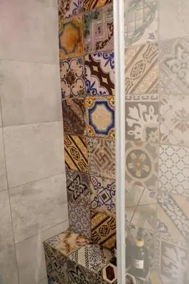 a bathroom with a bunch of tiles on the wall at Valverde Home in Palermo