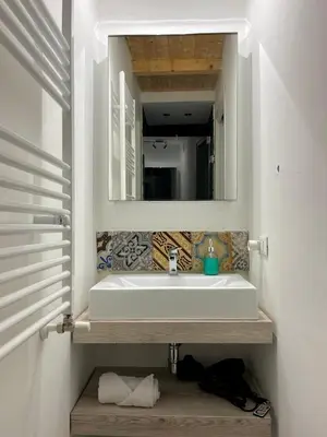 a bathroom with a sink and a mirror at Valverde Home in Palermo