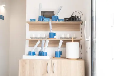 a shelf with blue utensils in a kitchen at Il Cortile Isola Casa Vacanze in Isola delle Femmine