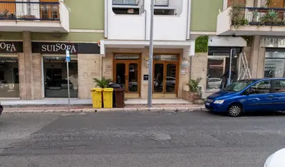 a blue car parked in front of a building at Room 112 Oltremare in Bagheria