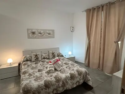 a bedroom with a bed with shoes on it at Ciccio's House in Palermo